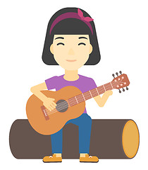 Image showing Woman playing guitar.