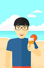 Image showing Tourist with cocktail on the beach.