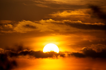 Image showing sunset with sun clouds over clouds