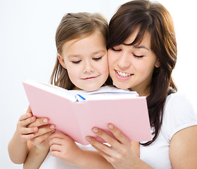 Image showing Mother is reading book with her daughter