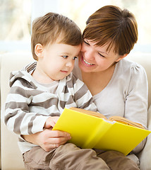 Image showing Mother is reading book for her son