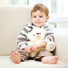 Image showing Little boy is holding his teddy bear