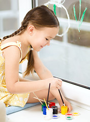 Image showing Portrait of a cute girl playing with paints