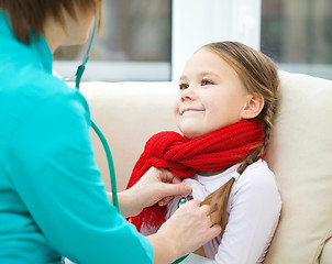 Image showing Doctor is examining little girl using stethoscope