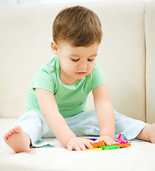 Image showing Little boy playing with toys