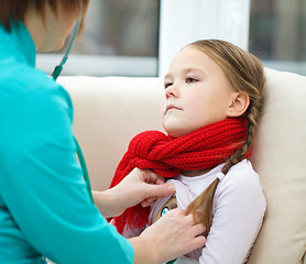 Image showing Doctor is examining little girl using stethoscope