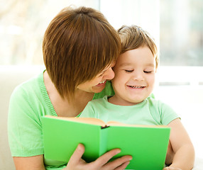 Image showing Mother is reading book for her son