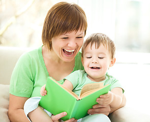Image showing Mother is reading book for her son