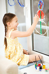 Image showing Portrait of a cute girl playing with paints