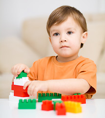 Image showing Boy is playing with building blocks