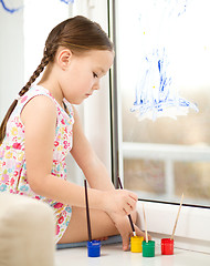 Image showing Portrait of a cute girl playing with paints