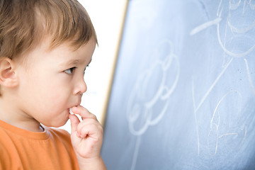 Image showing Little boy is biting chalk