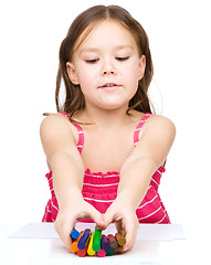 Image showing Little girl is drawing using a crayons