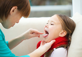 Image showing Doctor is examining little girl