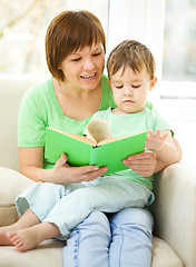 Image showing Mother is reading book for her son