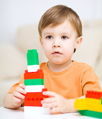 Image showing Boy is playing with building blocks