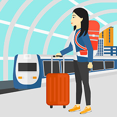 Image showing Woman with suitcase on wheels and briefcase.