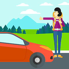 Image showing Young woman hitchhiking.