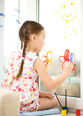 Image showing Portrait of a cute girl playing with paints