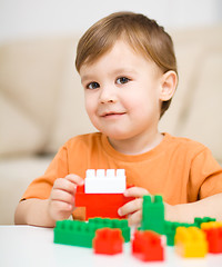 Image showing Boy is playing with building blocks