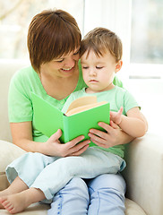 Image showing Mother is reading book for her son