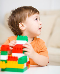 Image showing Boy is playing with building blocks