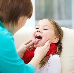 Image showing Doctor is examining little girl