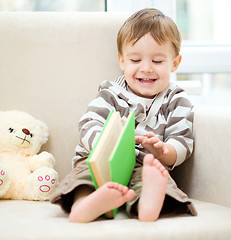 Image showing Little boy is reading book