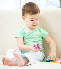 Image showing Little boy playing with toys