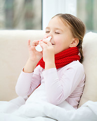 Image showing Little girl spraying her nose