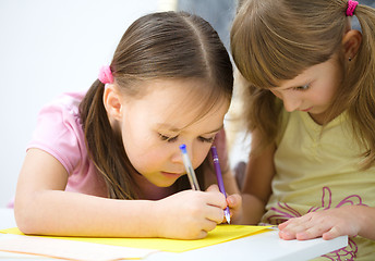 Image showing Little girls are writing using a pen