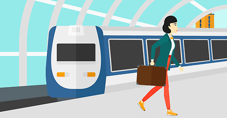 Image showing Woman going out of train.