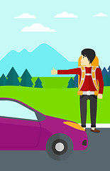 Image showing Young man hitchhiking.