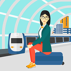 Image showing Woman sitting on railway platform.