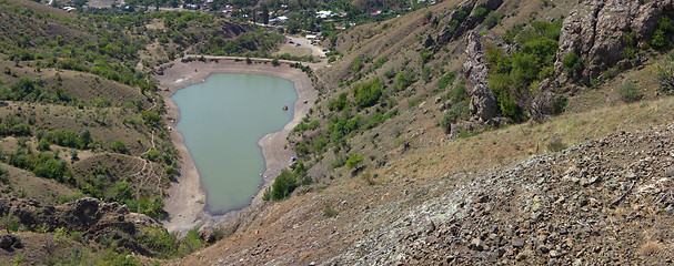 Image showing Dried out reservoir glistens silver in sun at noon panorama