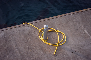 Image showing Dock post with a yellow line