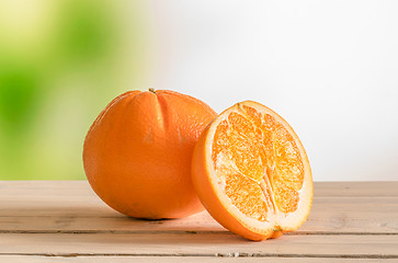 Image showing Orange fruit on a wooden outdoor table
