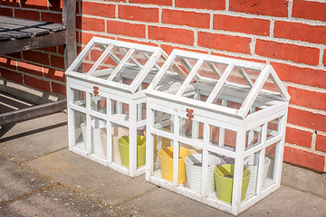 Image showing Small outdoors greenhouse in white colors