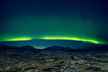 Image showing Northern lights over distant mountains