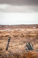 Image showing Barb wire on a fence in cloudy weather