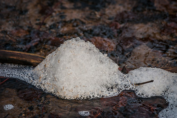 Image showing Last snow melting in a river