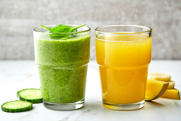 Image showing smoothie and juice glasses on gray kitchen table