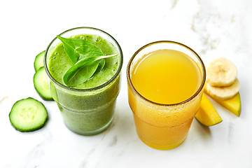 Image showing Glasses of green smoothie and yellow juice