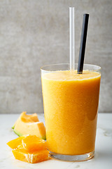 Image showing glass of orange and melon smoothie