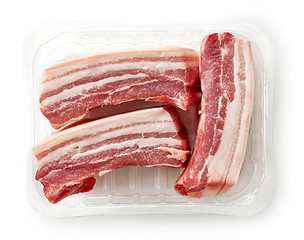 Image showing raw bacon pieces in plastic try