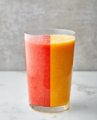 Image showing glass of red and yellow smoothie