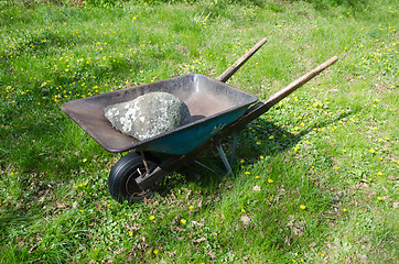 Image showing Wheelbarrow with a big stone