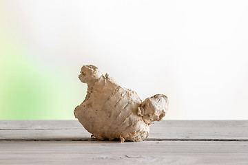 Image showing Ginger root on a wooden table