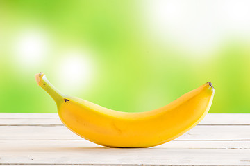 Image showing Single banana on a wooden desk