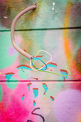 Image showing Wires coming out of a grungy wall with grafitti